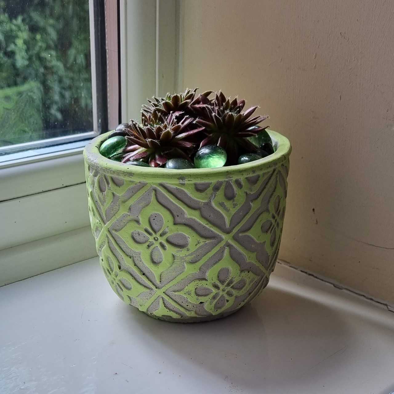 green pattern pot on window sill